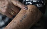A Holocaust survivor shows her number tattoo. (Christopher Furlong/Getty Images)