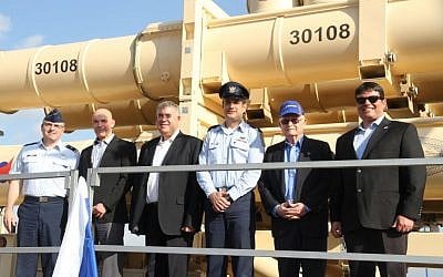 From right, Moshe Patel, head of the Defense Ministry's missile program, David Ivri, president of Boeing-Israel, Brig. Gen. Tzvika Haimovitch, head of the army's Aerial Defense Command, Boaz Levi, vice president of IAI's missile division, Danny Gold, the former head of the ministry's missile program, and Brig. Gen. William Cooley, of the US Air Force, stand in front of a Arrow 3 missile defense system that was delivered to the Israeli Air Force on January 18, 2017. (Defense Ministry) From right, Moshe Patel, David Ivri, Brig. Gen. Tzvika Haimovitch, Boaz Levi, Danny Gold and Brig. Gen. William Cooley stand in front of a Arrow 3 missile defense system that was delivered to the Israeli Air Force on January 18, 2017. (Defense Ministry)