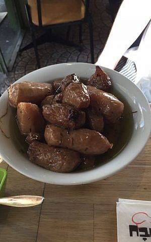 A bowl of Jerusalem artichoke confit; the best way to deal with the sometimes odious gasses emitted by this knotty tuber (Jessica Steinberg/Times of Israel)