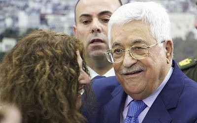 Palestinian Authority President poses for a photograph with an Israeli peace activist at the PA headquarters in Ramallah on January 5, 2017. (Dov Lieber/Times of Israel)