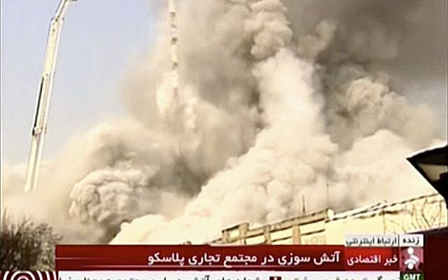 In this image made from video, a high-rise residential building collapses following a large fire, Thursday, Jan. 19, 2017, in Tehran, Iran. (IRINN via AP)