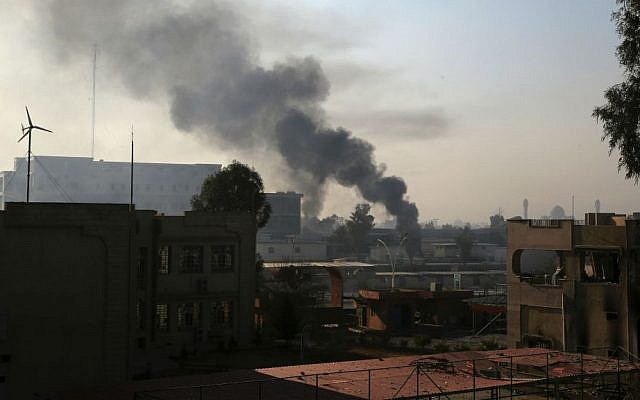 Smoke rises as Iraqi security forces fight against Islamic State inside Mosul University, in the eastern side of Mosul, Iraq, Saturday, Jan. 14, 2017. (AP Photo/Khalid Mohammed)