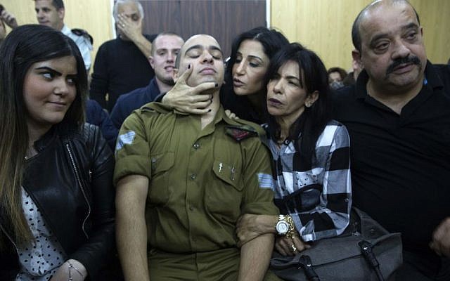 In this Wednesday, Jan. 4, 2017 file photo, Israeli soldier Sgt. Elor Azaria waits with his parents for the verdict inside the military court in Tel Aviv, Israel. ( Heidi Levine, Pool via AP)