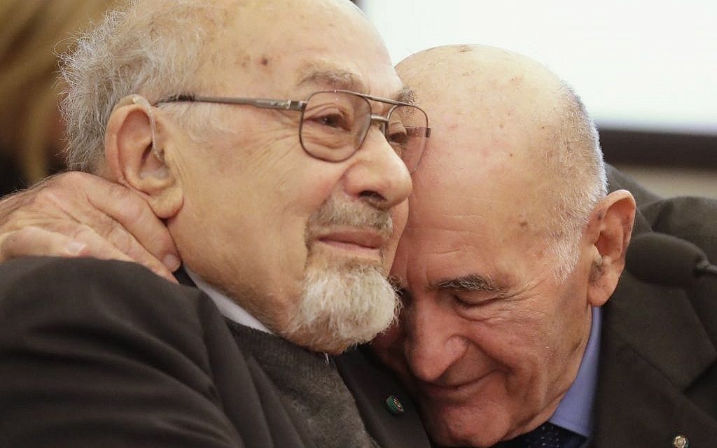 Holocaust survivors Sami Modiano, right, and Piero Terracina hug each other during an event on International Holocaust Remembrance Day, at Rome's Capitol Hill, Friday, Jan. 27, 2017. (AP Photo/Alessandra Tarantino)