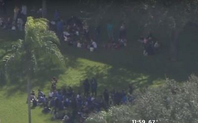 Screen capture of video showing people evacuated from a Jewish community center following a bomb hoax in Miami, Florida, January 9, 2017. (screen capture: YouTube/CBS Miami)