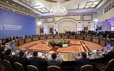 Delegations of Russia, Iran and Turkey hold talks on Syrian peace at a hotel in Astana, Kazakhstan, Monday, January 23, 2017. (AP Photo/Sergei Grits)