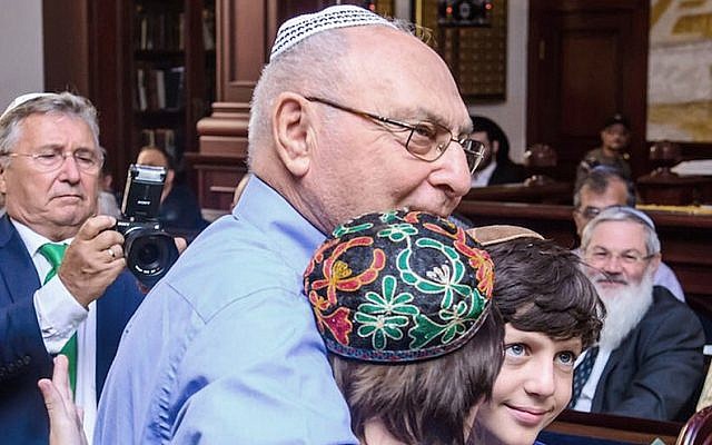 Haim Erez hugging the children of Yanush Ben Gal in Kazan, Sept. 4, 2016. (Limmud FSU via JTA)