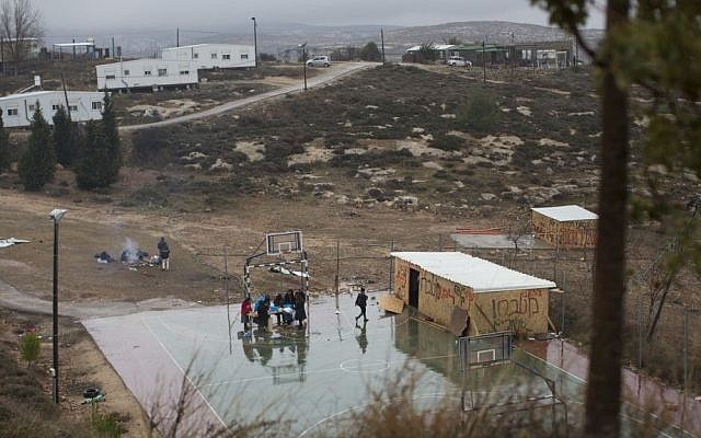 In this Sunday, December 18, 2016 file photo, Jewish settlers cook food on a basketball court in Amona, an unauthorized Israeli outpost in the West Bank, east of Ramallah. (AP Photo/Oded Balilty, File)