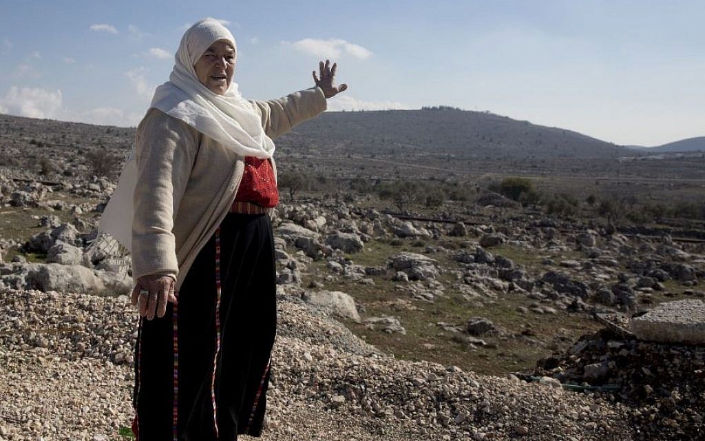 In this Monday, January 1, 2017 photo, Maryam Abdel-Kareem, an 82-year-old Palestinian, points to land held by the Jewish settlement of Amona, an unauthorized outpost in the West Bank, near the village of Silwad. (AP/Majdi Mohammed) In this Monday, January 1, 2017 photo, Maryam Abdel-Kareem, an 82-year-old Palestinian, points to land held by the Jewish settlement of Amona, an unauthorized outpost in the West Bank, near the village of Silwad. (AP/Majdi Mohammed)