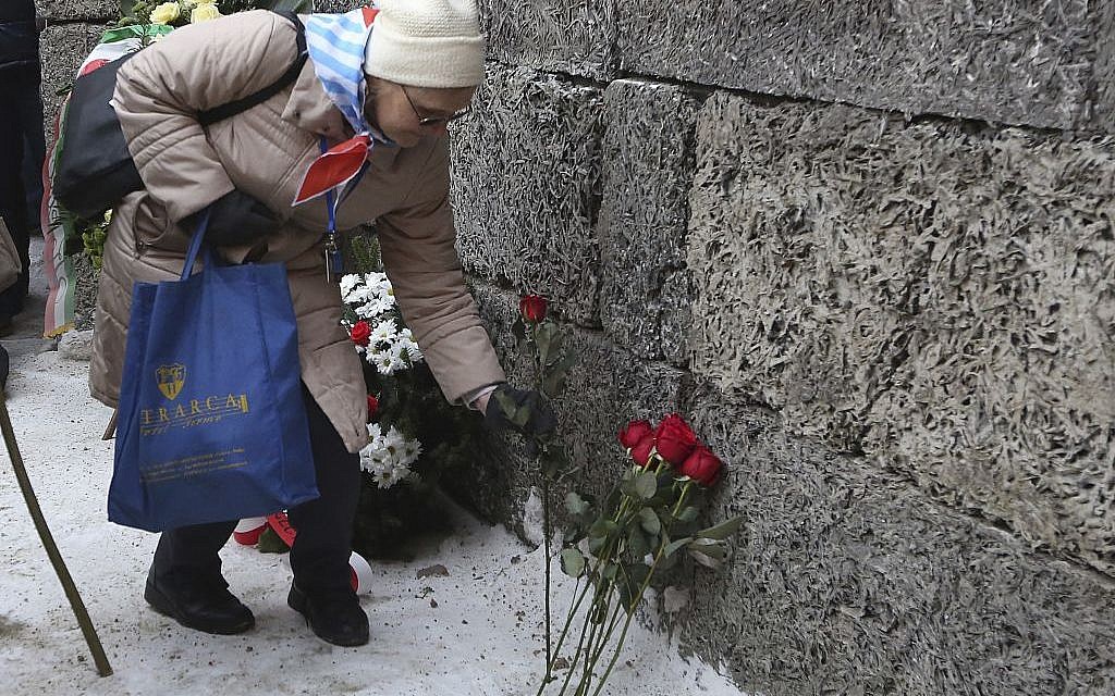 A Holocaust survivor commemorates the people killed by the Nazis at the former Auschwitz Nazi death camp in Oswiecim, Poland, Friday, Jan. 27, 2017, on the International Holocaust Remembrance Day that marks the liberation of the Auschwitz Nazi death camp on Jan. 27, 1945. (AP Photo/Czarek Sokolowski)