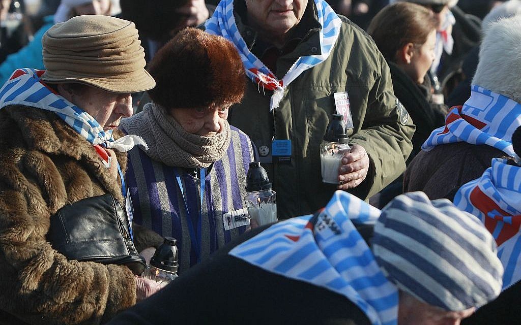 Holocaust survivors light candles at the International Monument to the Victims of Fascism, after a ceremony marking the 72nd anniversary of the liberation of the Nazi death camp Auschwitz-Birkenau, in Oswiecim, Poland, Friday, Jan. 27, 2017, on the International Holocaust Remembrance Day. (AP Photo/Czarek Sokolowski)