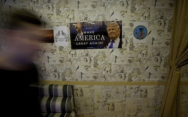 A visitor arrives for a party to mark the upcoming inauguration of Trump at a nightclub in Moscow, Russia, on Thursday, Jan. 19, 2017. Twenty-four hours before Donald Trump is to be sworn in as president of the United States, people gathered at a Moscow nightclub to celebrate his inauguration. (AP Photo/Ivan Sekretarev)