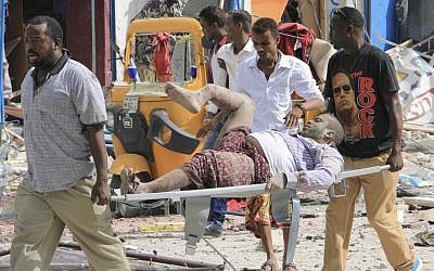 Somali men carry a civilian who was wounded in a suicide car bomb attack on a hotel in Mogadishu, Somalia, Wednesday, January 25, 2017. (AP Photo/Farah Abdi Warsameh) Somali men carry a civilian who was wounded in a suicide car bomb attack on a hotel in Mogadishu, Somalia, Wednesday, January 25, 2017. (AP Photo/Farah Abdi Warsameh)