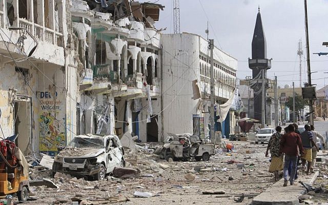 Somalis walk near a hotel and cars destroyed by a car bomb in Mogadishu, Somalia, on Wednesday, January 25, 2017. (AP Photo/Farah Abdi Warsameh) Somalis walk near a hotel and cars destroyed by a car bomb in Mogadishu, Somalia, on Wednesday, January 25, 2017. (AP Photo/Farah Abdi Warsameh)