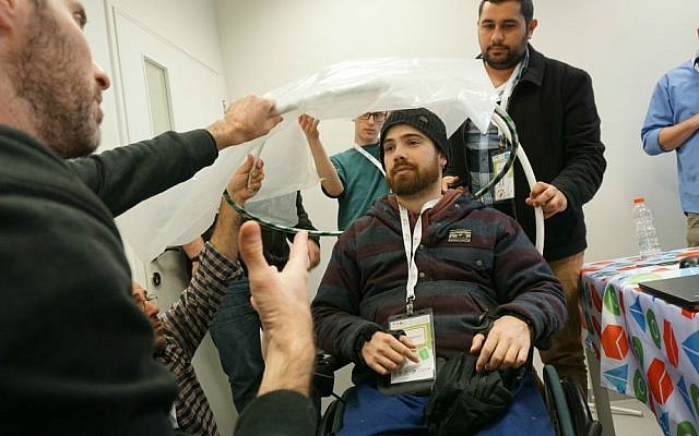 Tikkun Olam Makers teams create a hatchback canopy umbrella for the wheelchair of Drew McPherson (Courtesy) Tikkun Olam Makers teams create a hatchback canopy umbrella for the wheelchair of Drew McPherson (Courtesy)