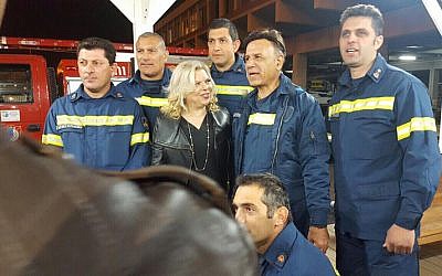 In this second image sent to Cypriot media, a Cypriot firefighter, standing to the right of Prime Minister Benjamin Netanyahu's wife Sara, is wearing a jacket with no ranks (Courtesy Cyprus Mail)