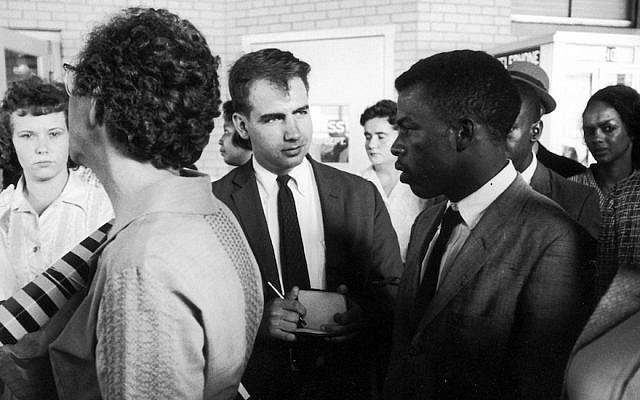Writer Calvin Trillin, center, interviewing John Lewis in Birmingham, Ala., as the Freedom Riders were boarding the bus for Montgomery in 1961 (Donald Uhrbrock/The LIFE Images Collection/Getty Images via JTA) Writer Calvin Trillin, center, interviewing John Lewis in Birmingham, Ala., as the Freedom Riders were boarding the bus for Montgomery in 1961 (Donald Uhrbrock/The LIFE Images Collection/Getty Images via JTA)