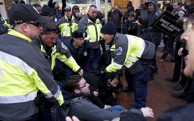 Police try to remove demonstrators from attempting to block people entering a security checkpoint, Friday, Jan. 20, 2017, ahead of President-elect Donald Trump's inauguration in Washington. ( AP/Jose Luis Magana) Police try to remove demonstrators from attempting to block people entering a security checkpoint, Friday, Jan. 20, 2017, ahead of President-elect Donald Trump's inauguration in Washington. ( AP/Jose Luis Magana)