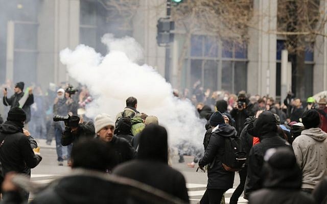 Police deploy smoke and pepper grenades during clashes with protesters in northwest Washington, Friday, Jan. 20, 2017. (Mark Tenally/AP) 