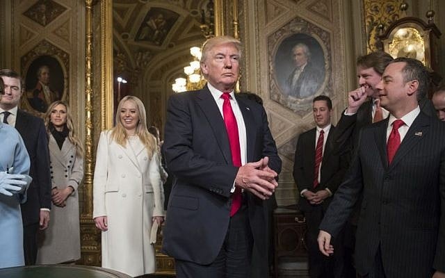 President Donald Trump leaves the President's Room of the Senate on Capitol Hill in Washington, Friday, Jan. 20, 2107, after he formally signed his cabinet nominations into law. He is joined at far left by his wife, first lady Melania Trump and daughter Tiffany Trump. At far right is Chief of Staff Reince Priebus, with White House counsel Donald McGahn, second from right. (AP Photo/J. Scott Applewhite, Pool)