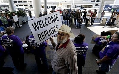 Demonstrators chant outside Tom Bradley International Terminal during a protest by airport service workers from United Service Workers West union Monday, Jan. 30, 2017, at Los Angeles International Airport. (AP/Chris Carlson)