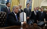 President Donald Trump shows off a signed executive order to reinstitute a policy barring any recipient of US assistance from performing or promoting abortions abroad with money they receive from non-US sources,  January 23, 2017. (AP Photo/Evan Vucci)