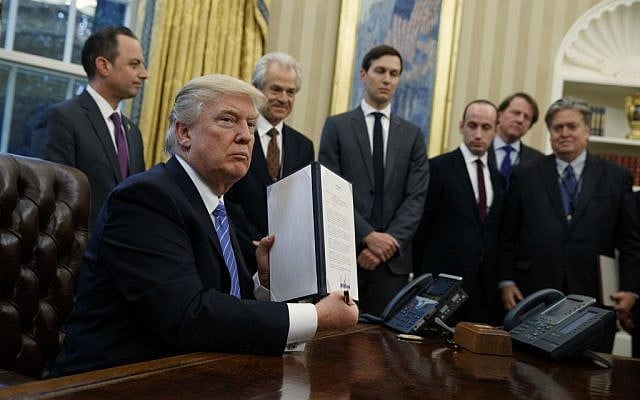 President Donald Trump shows off a signed executive order to reinstitute a policy barring any recipient of US assistance from performing or promoting abortions abroad with money they receive from non-US sources, January 23, 2017. (AP Photo/Evan Vucci) President Donald Trump shows off a signed executive order to reinstitute a policy barring any recipient of US assistance from performing or promoting abortions abroad with money they receive from non-US sources, January 23, 2017. (AP Photo/Evan Vucci)