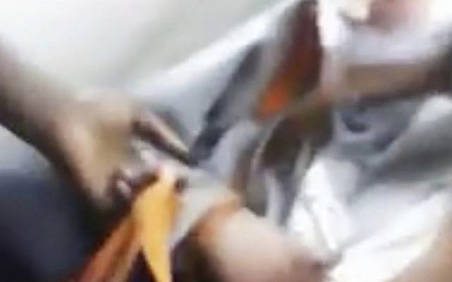 This image from a video that was broadcast live on Facebook and later posted on Vidme shows a frame in which a man, right, is assaulted in Chicago. The video shows the man with his mouth taped shut as a woman and other people cut off his shirt and hair with a knife, and someone pushes his head with his or her foot. Chicago Police Superintendent Eddie Johnson said Wednesday, Jan. 4, 2017, that the victim has mental health challenges, and he called the video 'sickening.' (Vidme via AP) This image from a video that was broadcast live on Facebook and later posted on Vidme shows a frame in which a man, right, is assaulted in Chicago. The video shows the man with his mouth taped shut as a woman and other people cut off his shirt and hair with a knife, and someone pushes his head with his or her foot. Chicago Police Superintendent Eddie Johnson said Wednesday, Jan. 4, 2017, that the victim has mental health challenges, and he called the video 'sickening.' (Vidme via AP)