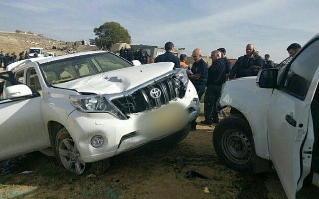 Israeli police stand next to a vehicle that rammed into police officers in the Bedouin village of Umm al-Hiran in the Negev desert, January 18, 2017. (Israel Police) Israeli police stand next to a vehicle that rammed into police officers in the Bedouin village of Umm al-Hiran in the Negev desert, January 18, 2017. (Israel Police)