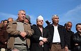 MK Ayman Odeh (center) of the Joint List and other Arab Israeli leaders stand at the scene of fatal clashes in the Bedouin village of Umm al-Hiran, in which Odeh was injured, on Wednesday, January 18, 2017 (courtesy)