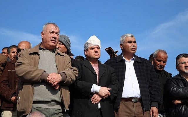 MK Ayman Odeh (center) of the Joint List and other Arab Israeli leaders stand at the scene of fatal clashes in the Bedouin village of Umm al-Hiran, in which Odeh was injured, on Wednesday, January 18, 2017 (courtesy) MK Ayman Odeh (center) of the Joint List and other Arab Israeli leaders stand at the scene of fatal clashes in the Bedouin village of Umm al-Hiran, in which Odeh was injured, on Wednesday, January 18, 2017 (courtesy)