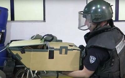 A sapper transporting an old grenade discovered in Tel Aviv's Haganah Museum, January 5, 2017 (Screen capture: YouTube)