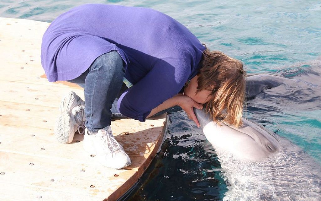 Trainers at the Dolphin Reef use noisemakers to call on the dolphins, who can recognize the sound of each trainer's individual noisemaker. (Shmuel Bar-Am)