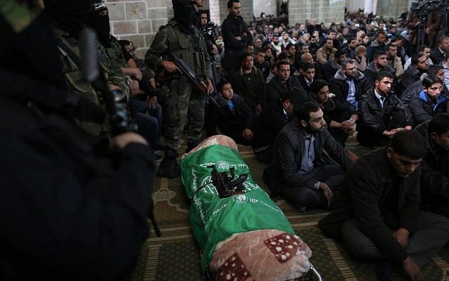 Hamas militants surround the body of a slain fighter at al-Omari Mosque in Gaza City on March 17, 2013. (Wissam Nassar/ Flash 90) Hamas militants surround the body of a slain fighter at al-Omari Mosque in Gaza City on March 17, 2013. (Wissam Nassar/ Flash 90)