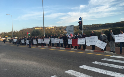 Arab-Israelis hold protest banners against the demolition of homes in the unrecognized Bedouin village of Umm al-Hiran, January 19, 2016. (Courtesy)