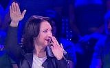 Lithuanian actress and former lawmaker Asta Baukute giving a Nazi-style salute on the Lithuanian 'Guess the Melody' game show, January 2017. (screen capture: 15min.lt)