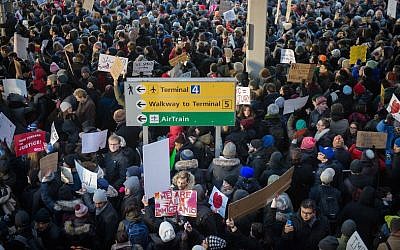 Protesters against Donald Trump's executive order to suspend refugee arrivals and impose tough controls on travelers from Iran, Iraq, Libya, Somalia, Sudan and Syria gather at JFK International Airport in New York on January 28, 2017. (BRYAN R. SMITH/AFP/Getty Images)