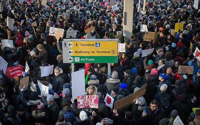 Protesters against Donald Trump's executive order to suspend refugee arrivals and impose tough controls on travelers from Iran, Iraq, Libya, Somalia, Sudan and Syria  gather at  JFK International Airport in New York on January 28, 2017 . (Photo by BRYAN R. SMITH/AFP/Getty Images)