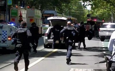 Police running to a scene where a car hit pedestrians in Melbourne, Australia, on January 20, 2017. (screen capture: Twitter)