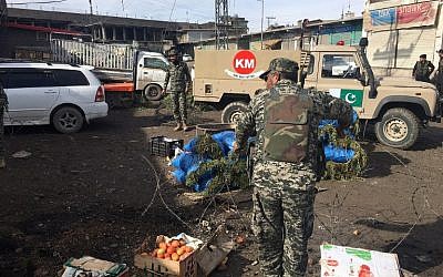 Pakistani security officials inspect the site of a bomb explosion at a vegetable market in Parachinar city, the capital of Kurram tribal district on the Afghan border on January 21, 2017.  (AFP PHOTO / ALI JAN)