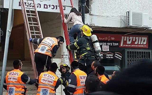 Rescue services evacuate people from a hotel that caught fire in the northern city of Safed, January 8, 2016. (Fire and Rescue Services)