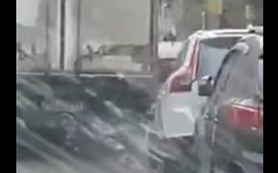 A still image taken from a cell phone video shows a truck driving bashing into parked cars on a narrow street in Tel Aviv on January 26, 2017 (screen capture: YouTube)