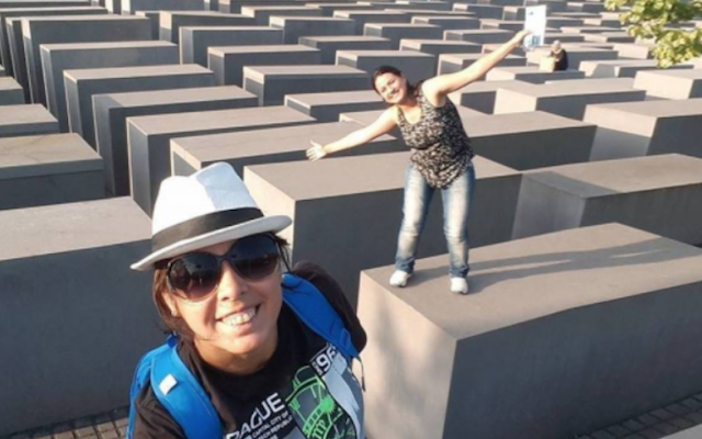 This picture shows a woman balancing on top of a memorial to Holocaust victims. (Screenshot from Yolocaust) 