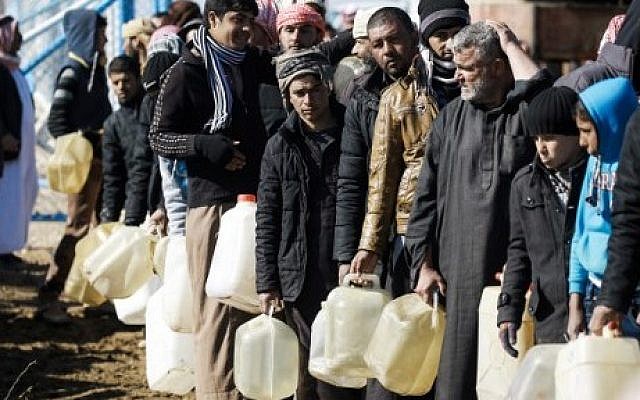 Refugees who fled the Iraqi city of Mosul due to the fighting between government forces and Islamic State (IS) group jihadists, line up for heating fuel at the UN-run al-Hol refugee camp in Syria's Hasakeh province, on January 29, 2017. (AFP/Delil Souleiman) Refugees who fled the Iraqi city of Mosul due to the fighting between government forces and Islamic State (IS) group jihadists, line up for heating fuel at the UN-run al-Hol refugee camp in Syria's Hasakeh province, on January 29, 2017. (AFP/Delil Souleiman)