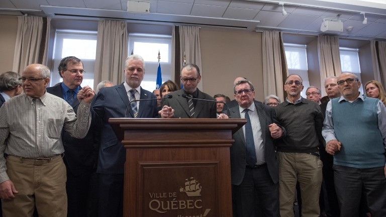 L-R:Salah Benrekik, member of the association "Ben Air"; Francois Blais Quebec Education Minister ; Philippe Couillard, Quebec prime minister; Mohamed Yangui, president of the Islamic Cultural Center of Quebec, Regis Labeaume, Quebec city mayor; Boufeldja Benabdallah, co-founder of the Islamic Cultural Center of Quebec and Mohamed Labidi, vice- president of the Islamic Cultural Center of Quebec hold hands in solidarity during a press conference January 30, 2017 at the city hall in Quebec City. (AFP Photo/Alice Chiche) L-R:Salah Benrekik, member of the association "Ben Air"; Francois Blais Quebec Education Minister ; Philippe Couillard, Quebec prime minister; Mohamed Yangui, president of the Islamic Cultural Center of Quebec, Regis Labeaume, Quebec city mayor; Boufeldja Benabdallah, co-founder of the Islamic Cultural Center of Quebec and Mohamed Labidi, vice- president of the Islamic Cultural Center of Quebec hold hands in solidarity during a press conference January 30, 2017 at the city hall in Quebec City. (AFP Photo/Alice Chiche)