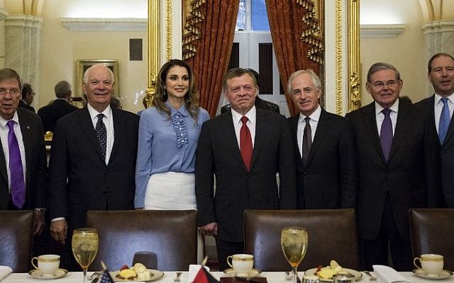 King Abdullah II, center, and Queen Rania of Jordan pose for a photo with, from left to right, Sen. Johnny Isakson (R-GA), Sen. Ben Cardin (D-MD), Sen. Bob Corker (R-TN), Sen. Bob Menendez (D-NJ), and Sen. Tom Udall (D-NM), on Capitol Hill in Washington, DC, on February 1, 2017. (AFP/ ZACH GIBSON)