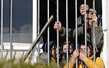 Israeli settlers barricade themselves inside a building on the second day of an Israeli police operation to evacuate the illegal Amona outpost on February 2, 2017. (AFP Photo/Thomas Coex)