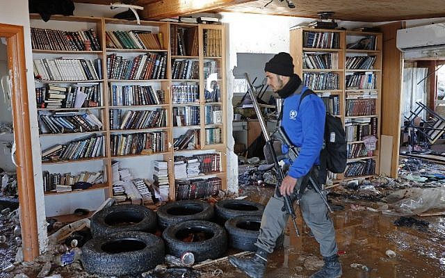 A policeman walks inside the Amona synagogue where youths barricaded themselves prior to being evicted on February 2, 2017 ( AFP PHOTO / Thomas COEX)
