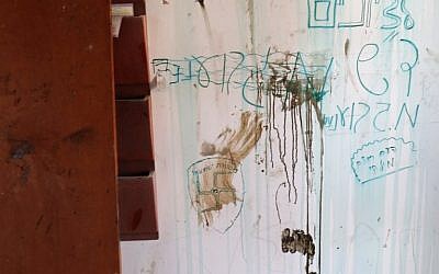 Graffiti and swastikas on the wall on the Amona synagogue after youths barricaded themselves prior to being evicted on February 2, 2017 (AFP PHOTO / Thomas COEX)