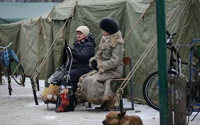 Elderly local residents in the flashpoint eastern town of Avdiivka, that sits just north of the pro-Russian rebels' de facto capital of Donetsk, arrive at heated tents set up for the elderly who have no heating in their homes on February 2, 2017. (Aleksey Filippov/AFP)